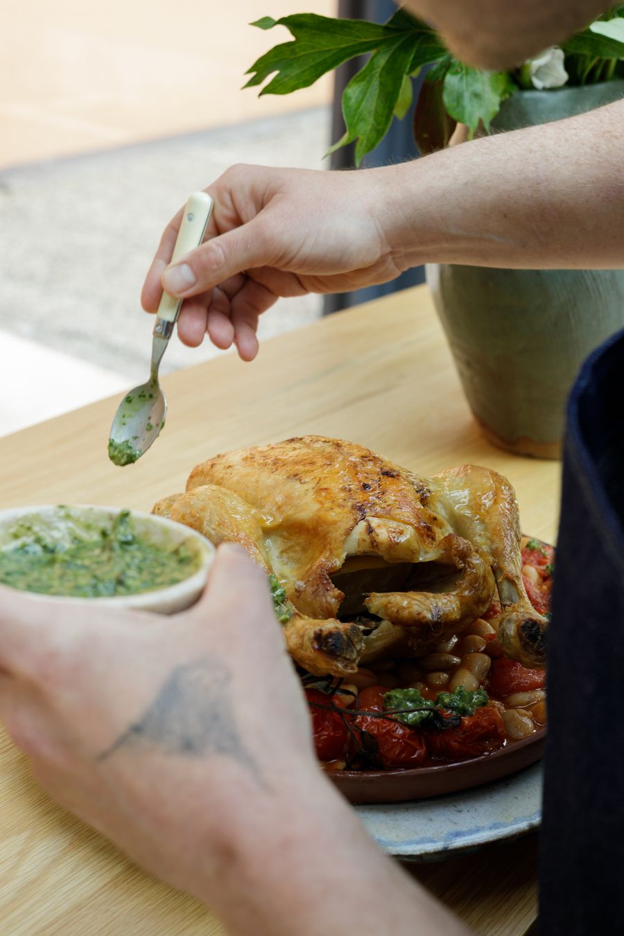 A roast served at the table in the Carpa, herb sauce spooned over